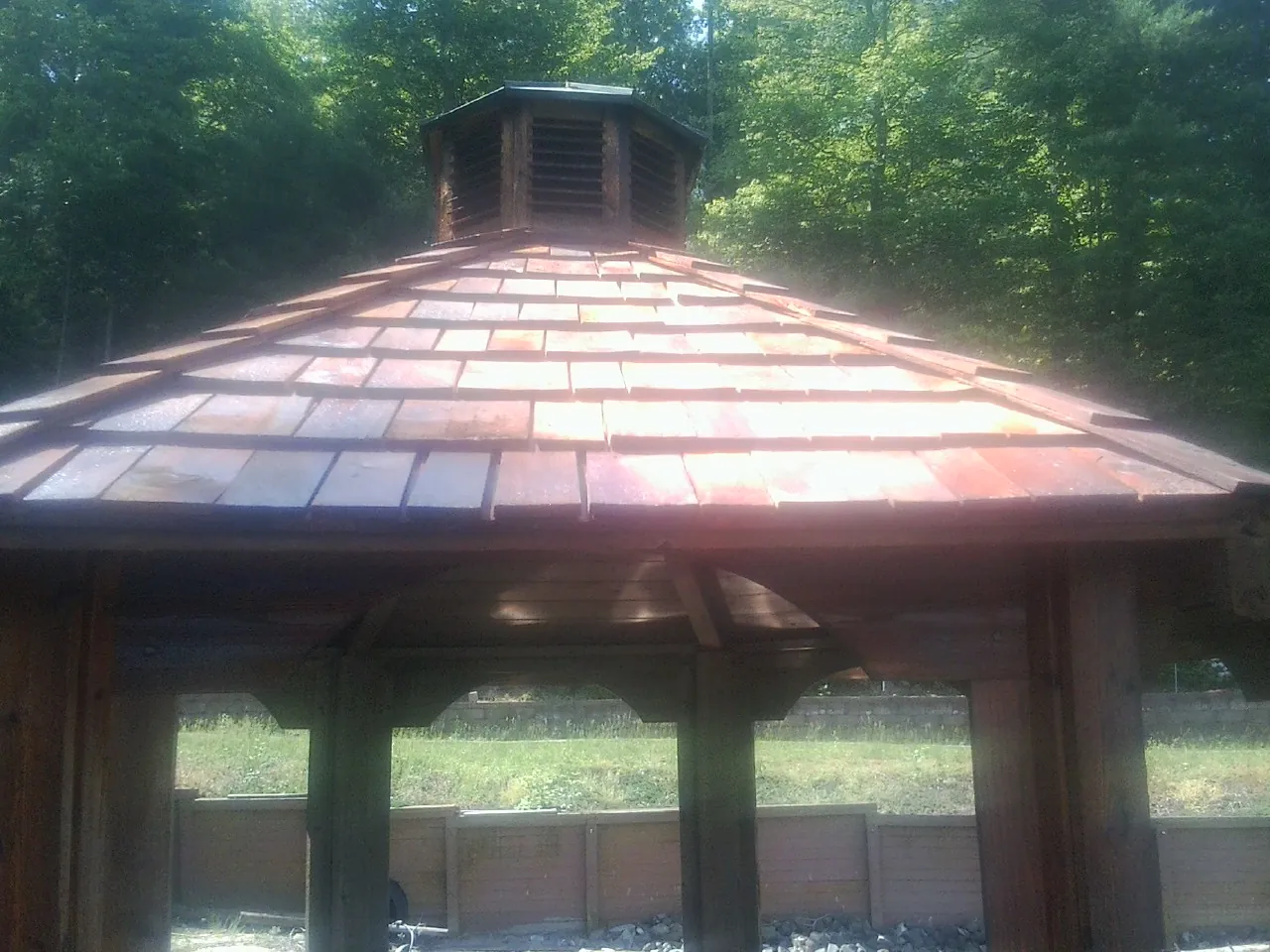 New cedar shake roof and cupola on a lakeside gazebo in Gaston